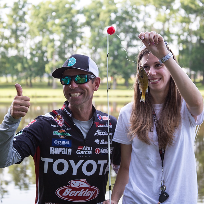 Ike Foundation | Ike and girl holding fish